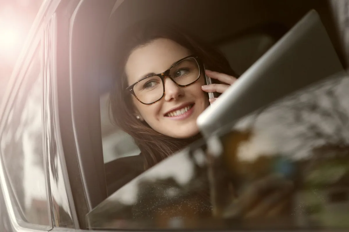 Driver on the phone in a car getting a Colorado SR-22 insurance quote